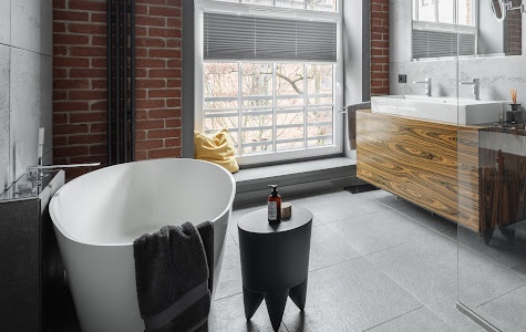 Industrial style bathroom with oval bathtub and walk in shower